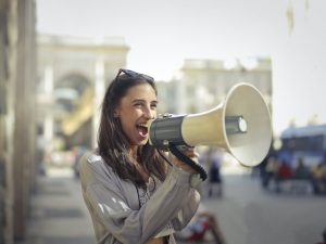 There is a woman speaking into a megaphone.